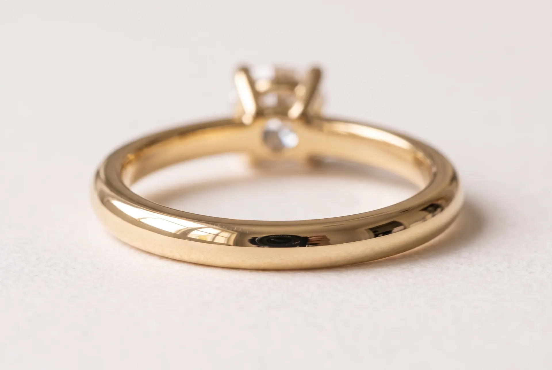 The polished band shows the room back: the window, and the lens of the camera.